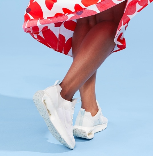 legs of woman in floral skirt nike air max