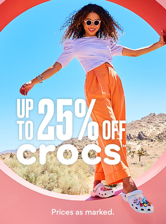 woman in orange pants and purple top wearing crocs with jibbitz. up to 25% off crocs