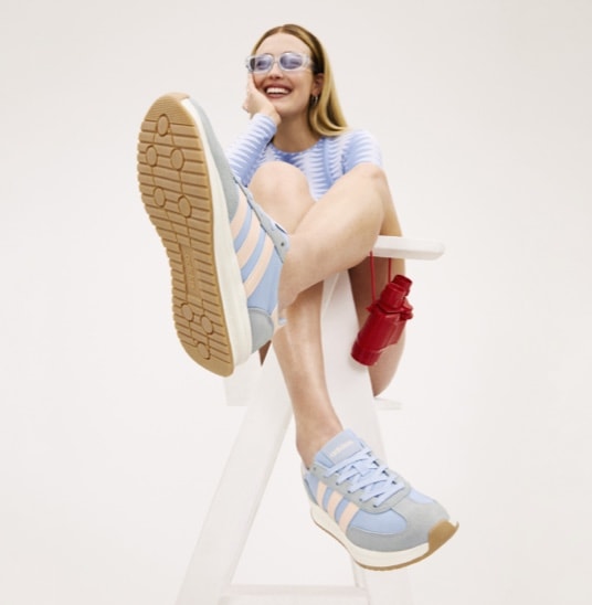 Woman wearing light blue adidas sneakers