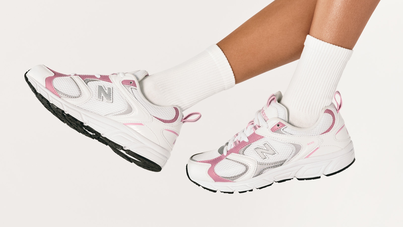 Pink and white New Balance sneakers