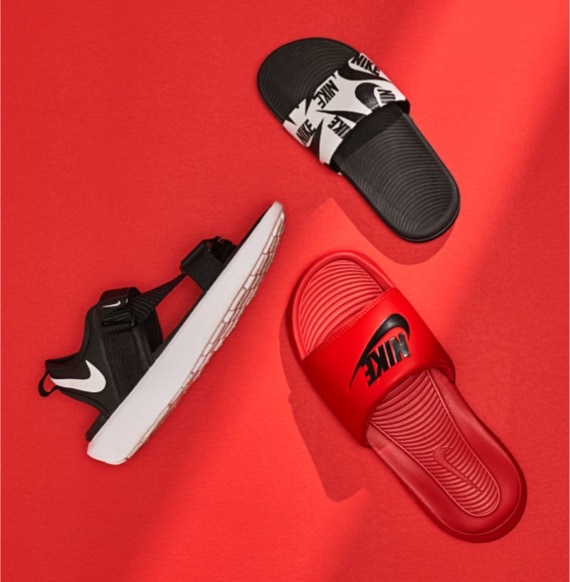 three sandals, the women Nike VIsta Sandal Black and white, the men Nike Victori Red and black, and the kids Nike Kawa White and black Logo sandal