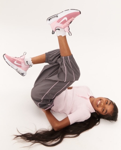 Girl wearing pink Nike shoes