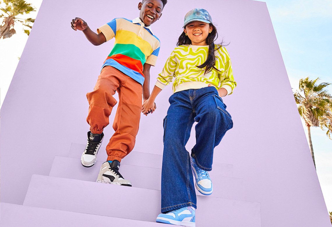 boy and girl wearing puma court sneakers