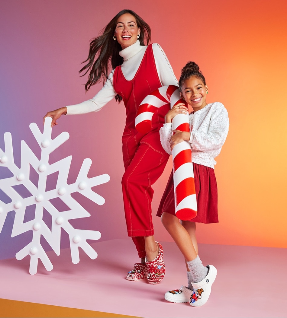 mother and daughter with giant snowflake wearing holiday crocs