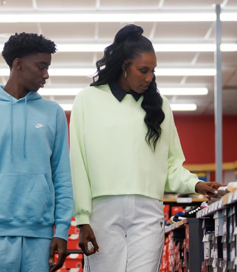 Lisa Leslie and son shopping in a Famous Footwear store