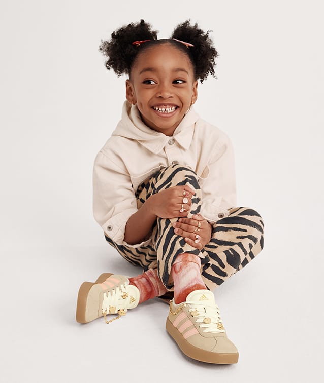 girl wearing kids character shoes
