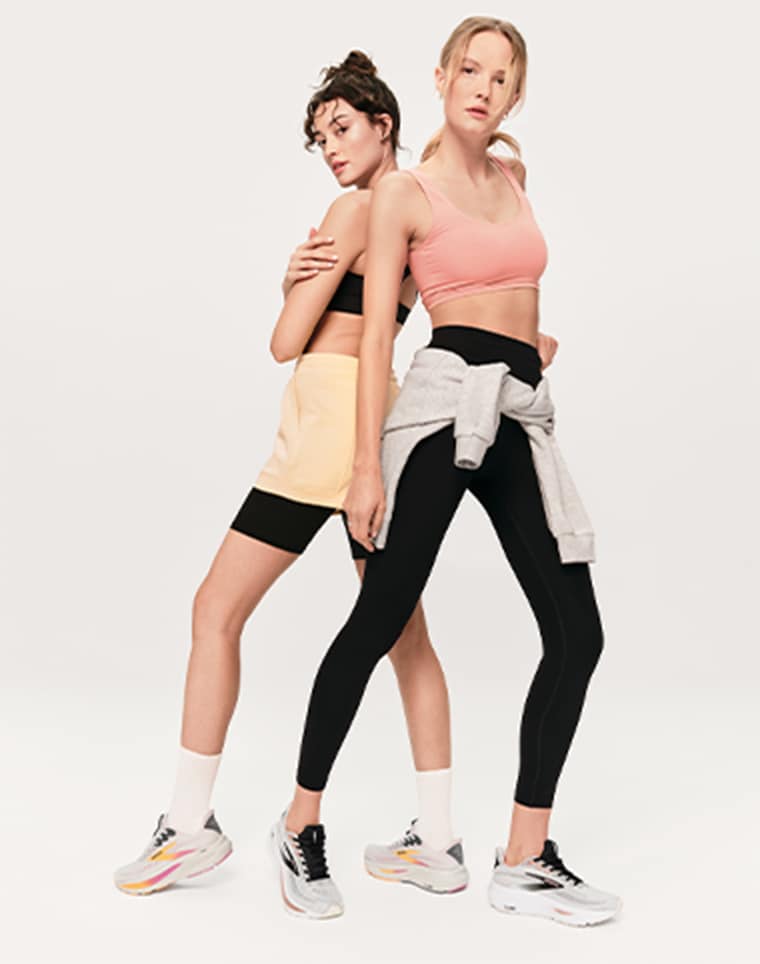 two women wearing brooks performance running sneakers
