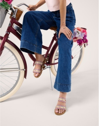 woman on a bike wearing spring detailed sandals