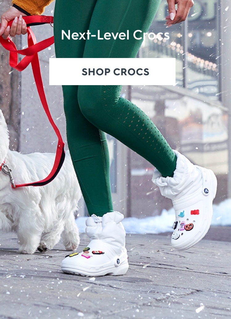 Woman wearing white Crocs Classic Fuzz Lined Neo Puff Boot with jibbitz