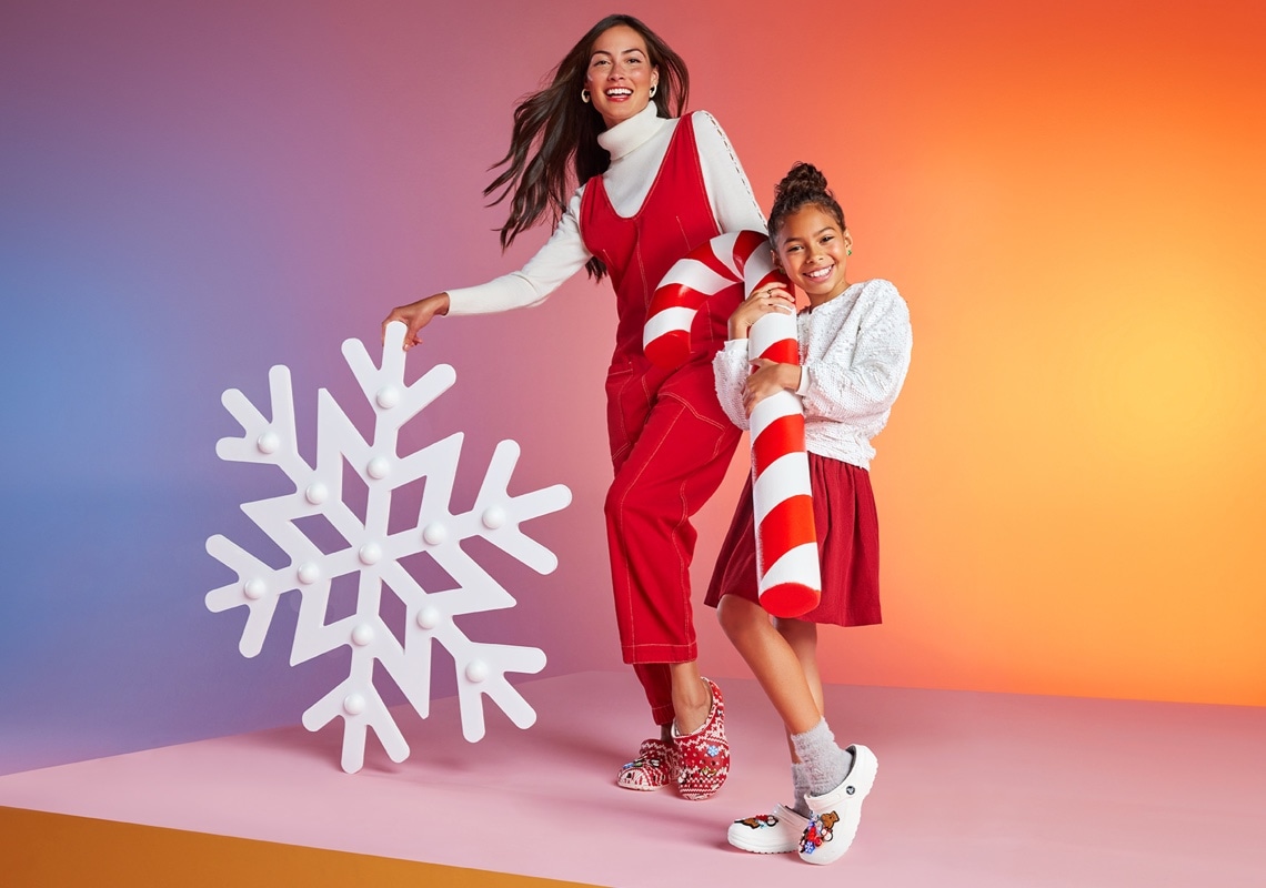 mother and daughter wearing holiday crocs with a giant snowflake and candycane 