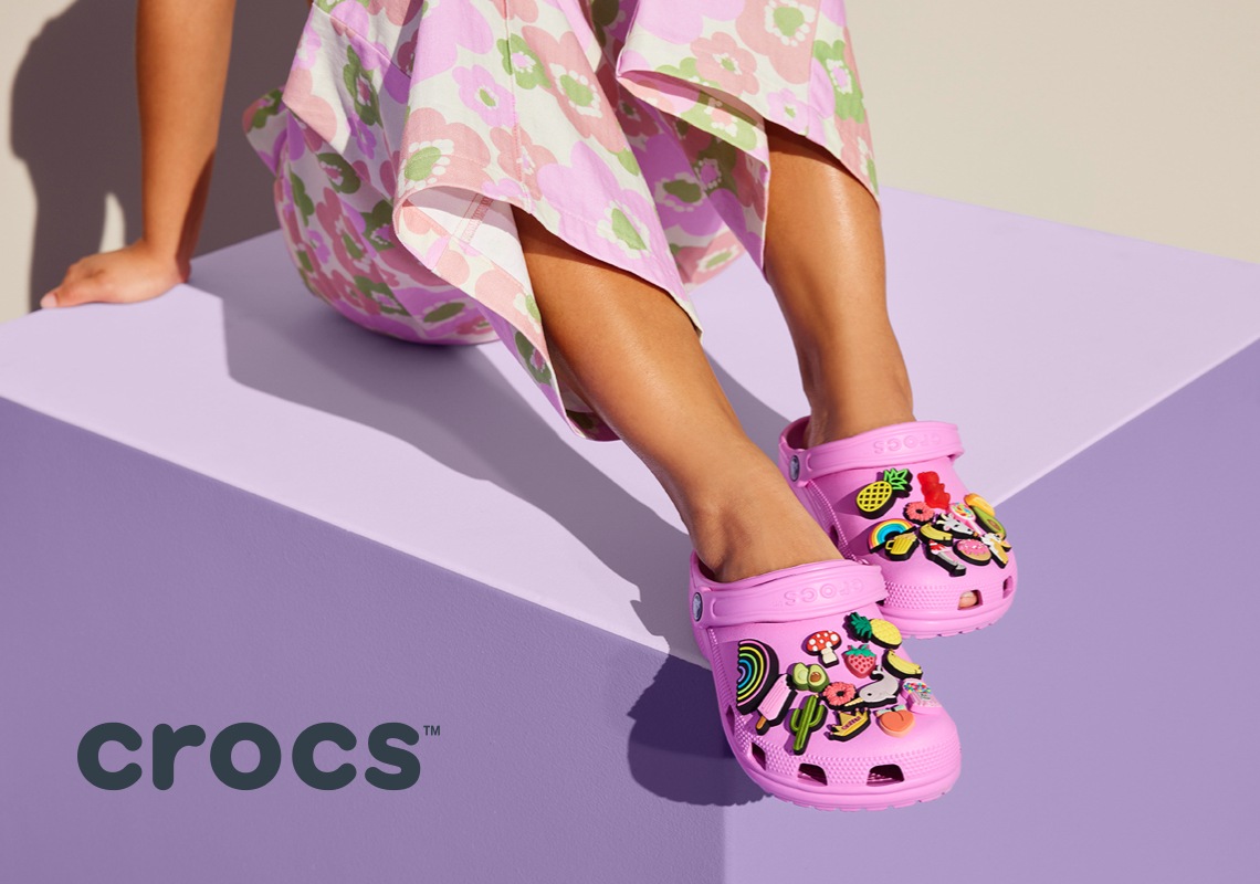 woman wearing classic crocs in pink with jibbitz