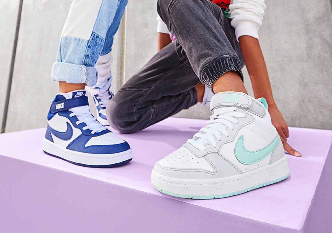 people wearing white nike tennis shoes with blue accents