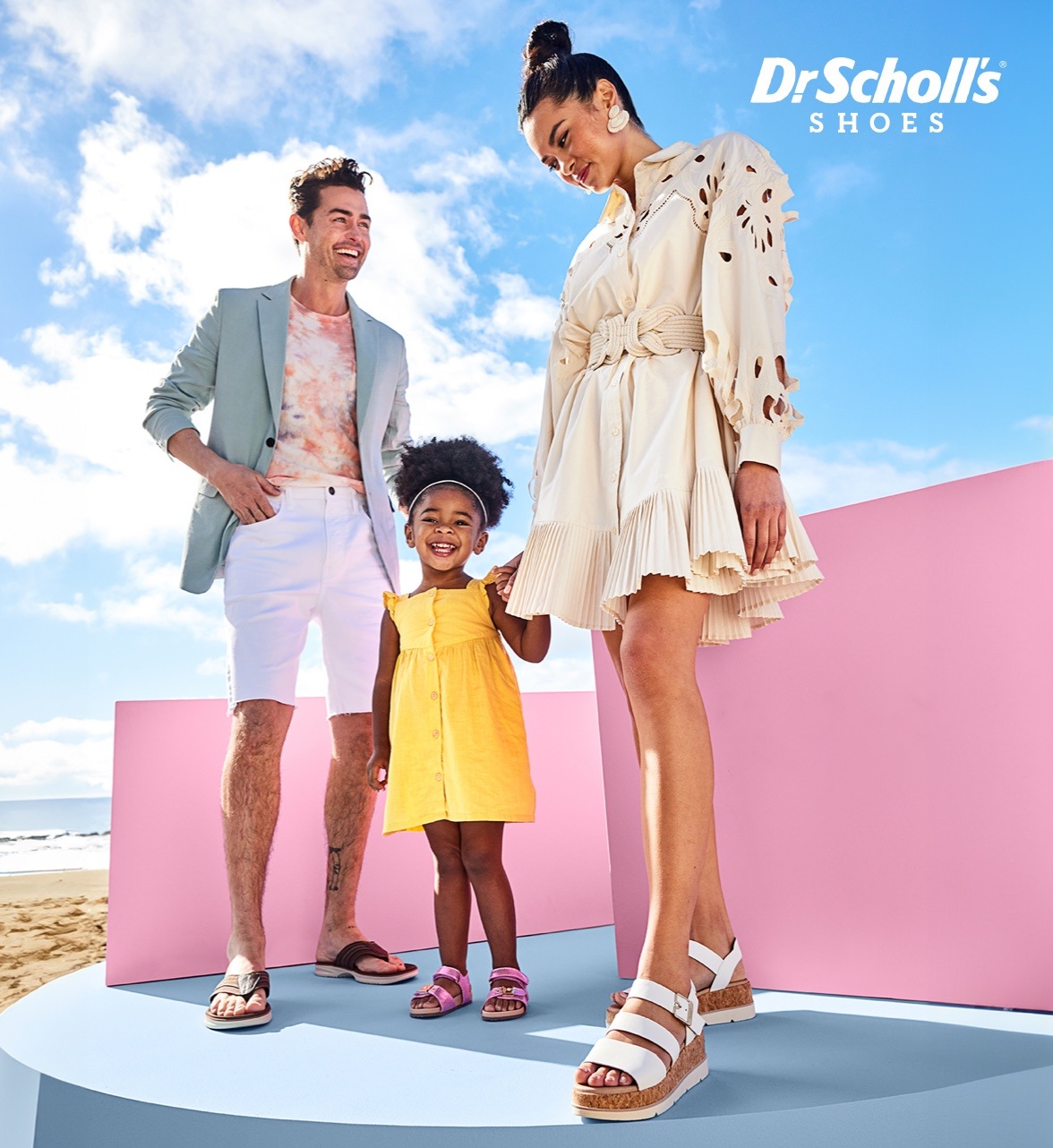 mom, dad and daughter holding hands wearing dr scholl's sandals