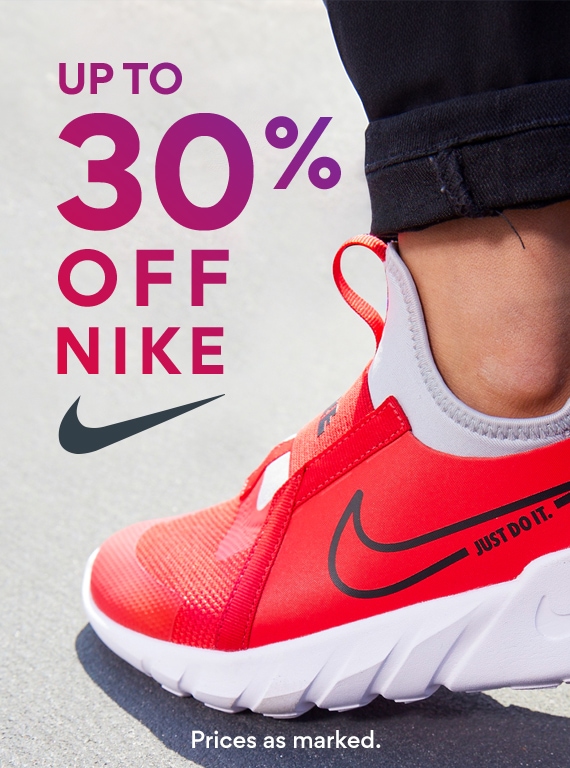 foot of person wearing red nike running shoes. up to 30% off nike