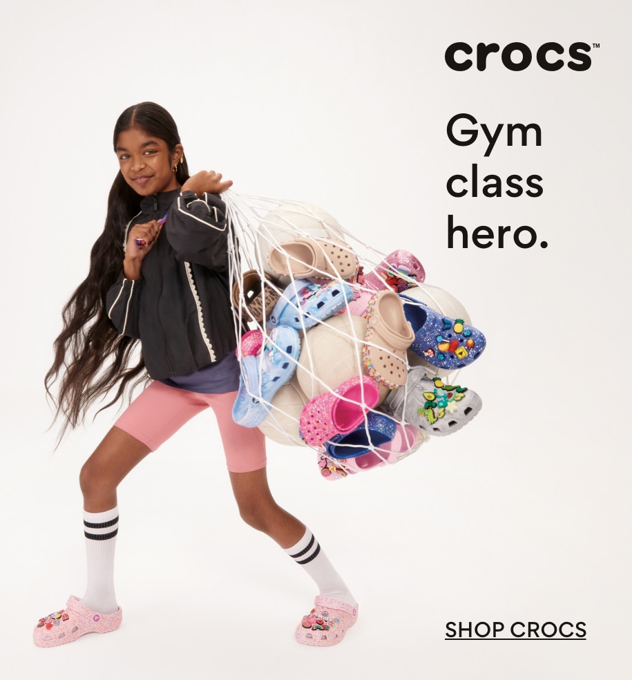 Girl wearing and carrying Crocs
