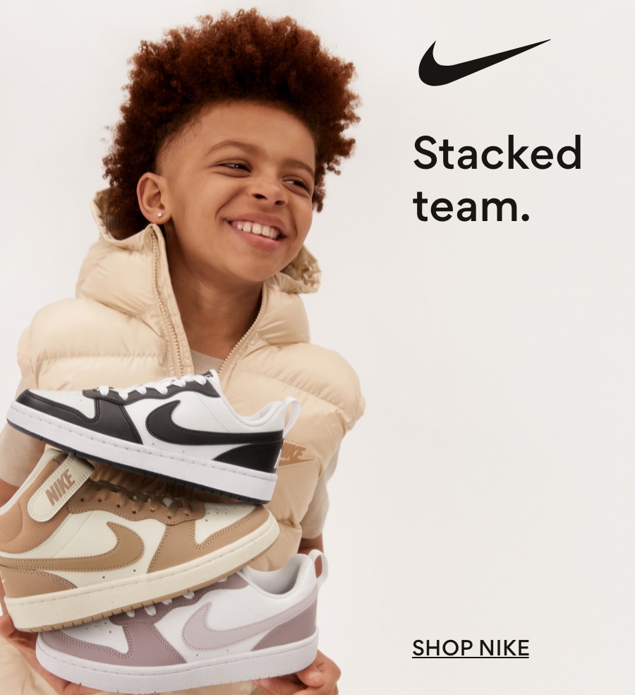 Boy holding Nike shoes