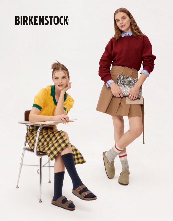 two women wearing birkenstock shoes