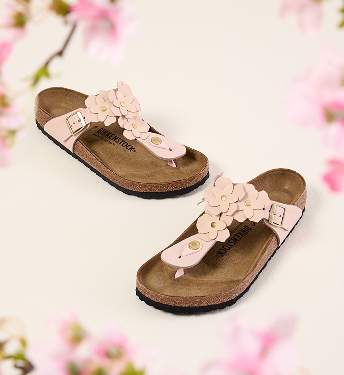 pink birkenstock gizeh sandals with flowers with flowers in the background