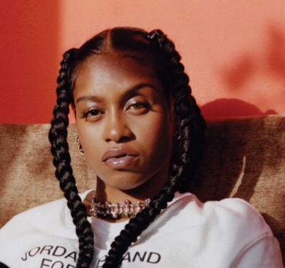 woman with braids looking into the camera