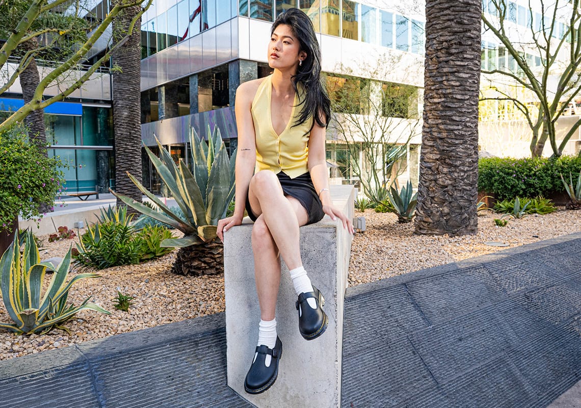 a girl wearing black doc martens
