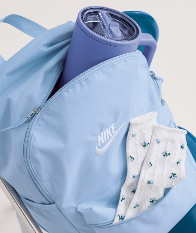 blue Nike backpack with hydrojug and socks