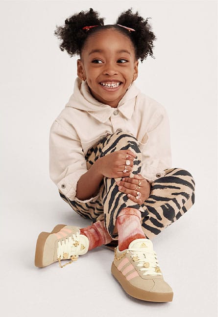 girl wearing tan adidas sneakers