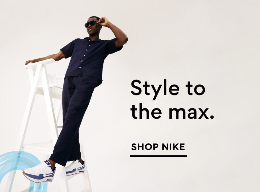 Man wearing Nike Air Max sneakers on ladder. Shop Nike