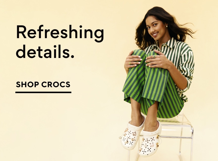 Women sitting in chair. Shop Crocs