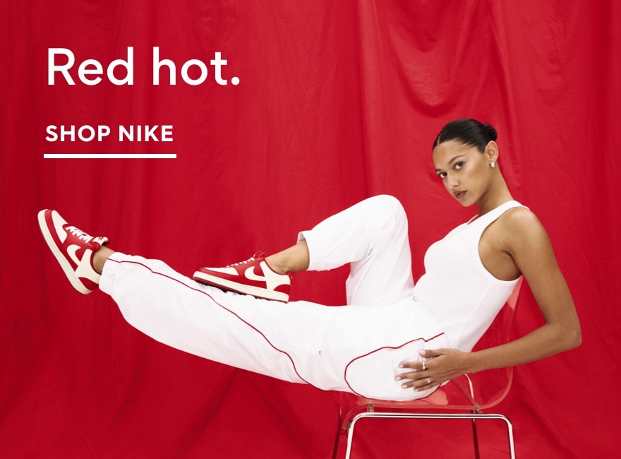 women sitting in chair. Shop Nike